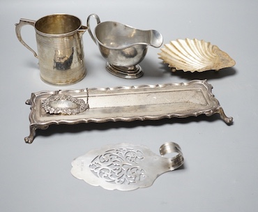 A George V silver sauceboat, an Edwardian silver pen tray and three other items including shell butter dish, 18oz.